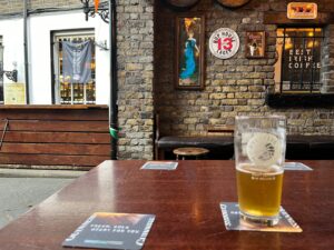 A glass of Rye River Upstream Pale Ale in the beer garden